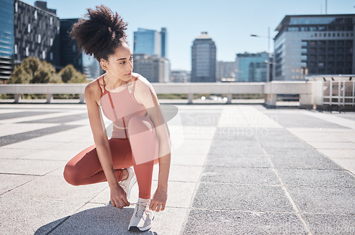 Image of Sports, fitness and black woman tie shoes getting ready for training in city. Face, thinking and female runner tying sneaker lace and preparing for workout jog, running or exercise outdoors on street