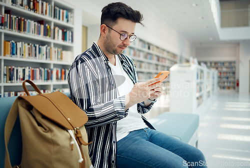 Image of Library, university and man with phone on sofa for education, research and checking social media. Networking, knowledge and male student on smartphone, mobile app and website in college bookstore