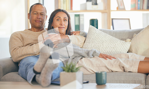 Image of Portrait, love and senior couple on sofa, relax and in living room for bonding, romance and weekend break. Romantic, old man and mature woman on couch in lounge, loving and enjoy retirement together