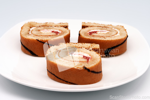 Image of Sliced roll on a plate.