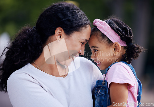 Image of Mother, daughter and hug in a park, love and sweet while bonding outdoor together. Black woman, girl and touching face in a garden for fun, precious and happy, laugh and relax in moment of motherhood