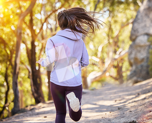 Image of Back, woman and running in nature, training and fitness for wellness, balance and healthy lifestyle. Female athlete, lady and runner in forest, practice or exercise for stress relief or summer break