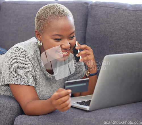 Image of Phone call, credit card and black woman on laptop for bank communication online with satisfied smile. Finance loan application approval and phone update for happy girl at home in South Africa.