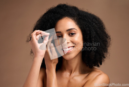 Image of Face, makeup and eyebrow pencil with a model black woman in studio on a brown background for a beauty product. Portrait, cosmetics and eyes with an attractive female inside to apply a cosmetic brand