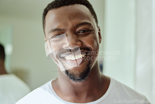 Image of Portrait, smile and black man on bathroom, home and house for facial skincare in Nigeria. Face of happy guy, morning routine and hygiene for male beauty, self care and cleaning cosmetics in apartment