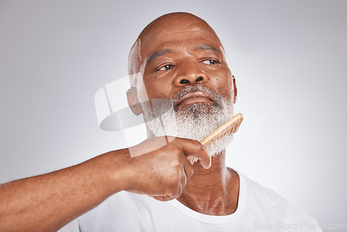 Image of Elderly, black man with comb for beard, beauty and grooming with hygiene and cosmetic care against studio background. Hair care mockup, brush body hair and face with hair treatment and cosmetics