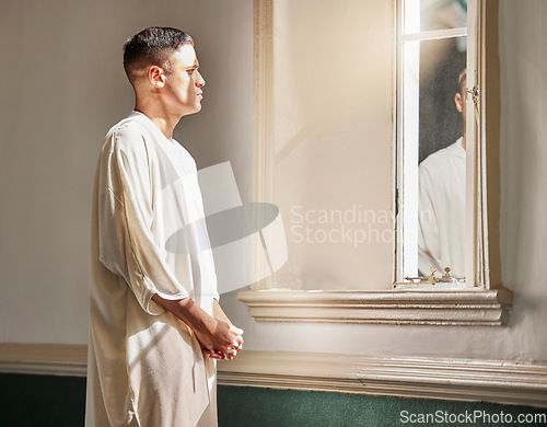 Image of Prayer, reflection and muslim man in mosque with mirror in Saudi Arabia, meditation and spiritual wellness in worship. Religion, hope and culture, islamic student thinking or praying during Ramadan.