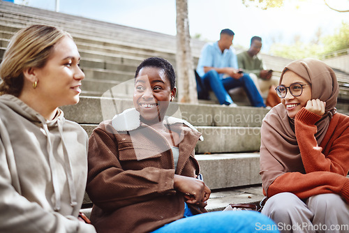 Image of Happy women, diversity or talking on university stairs, school steps or college campus in bonding class break. Smile, black woman or muslim students laughing in relax education group or learning rest