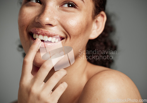 Image of Woman, sugar scrub and lips with smile for skincare, makeup or cosmetics against a grey studio background. Happy female smiling in happiness for facial cosmetic, lip dermatology or mouth exfoliation