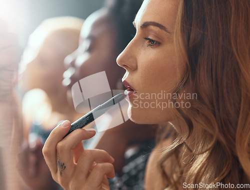 Image of Makeup, lipstick and woman in bathroom of nightclub, gen z friends getting ready for party or music concert. Cosmetics, diversity and women backstage at theater, fashion show or dark night club.