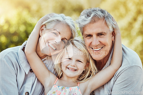 Image of Grandparents, park and child hug portrait with a young girl and elderly people with love and smile. Care, bonding together and nature of a family feeling happy with kid and elderly grandparent
