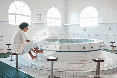 Image of Islam, ablution and man washing before prayer in bathroom at mosque in Iran, spiritual cleaning ritual. Islamic culture, water and worship, muslim guy in cleansing care routine to prepare for praying