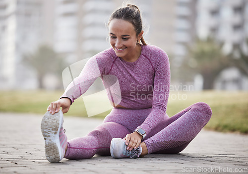 Image of Exercise, woman and city fitness while stretching on floor outdoor at a park for health and wellness. Athlete female sitting for warm up workout and running for healthy lifestyle, energy and body