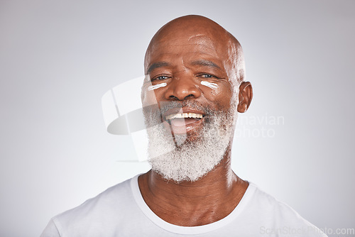 Image of Black man, skincare and facial cream on healthy skin in studio for self care with dermatology and cosmetics product. Face portrait of happy senior male with lotion for glow, health and wellness