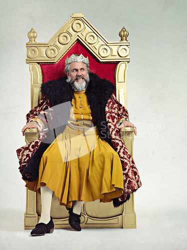 Image of King, royalty and angry man on throne in studio isolated on a gray background mockup.Thinking, medieval and annoyed senior male, upset leader or frustrated ruler with crown sitting on golden seat.