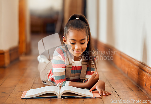 Image of Knowledge, black girl and reading on the floor, smile or hobby for learning, creative or relax on weekend. Young lady, African American female on ground or book for story time, literature or chilling