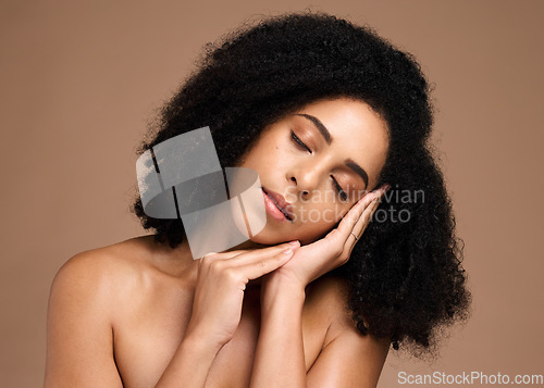 Image of Beauty, face and skincare with a model black woman in studio on a brown background for antiaging cosmetics. Facial, hair and wellness with an attractive young female posing on a wall for treatment