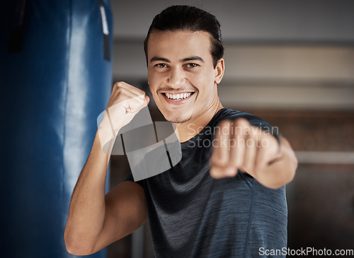 Image of Man, smile portrait and fist fight for fitness in gym for exercise workout, boxing training and sports wellness. Happy athlete, personal trainer and relax happiness for boxer cardio lifestyle in club