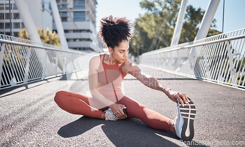 Image of City bridge, stretching legs and woman in fitness exercise, runner workout or training in sports shoes fashion. Warm up, focus and urban athlete on ground for pilates body, muscle and health goals