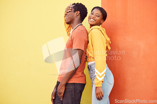 Image of Fashion portrait, people or couple of African friends relax with designer brand clothes, casual style and luxury apparel. Urban gen z aesthetic, black woman and man on orange yellow background wall