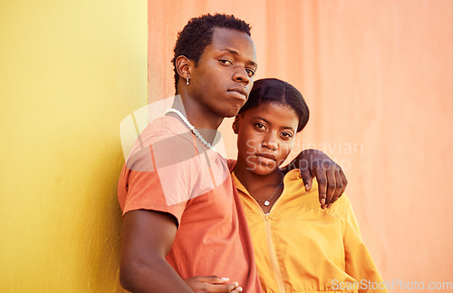 Image of Fashion portrait, people or couple of African friends relax with designer brand clothes, casual style and luxury apparel. Urban gen z aesthetic, black woman and man on orange yellow background wall