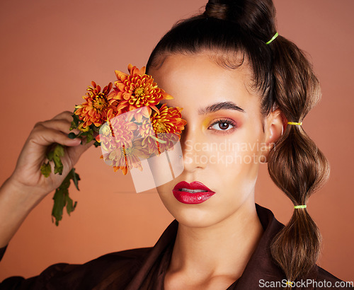 Image of Makeup, beauty or woman in studio with flowers for art fashion and natural facial cosmetics for self care. Face portrait, orange plants or girl model with red lipstick, eyeshadow and glowing skin