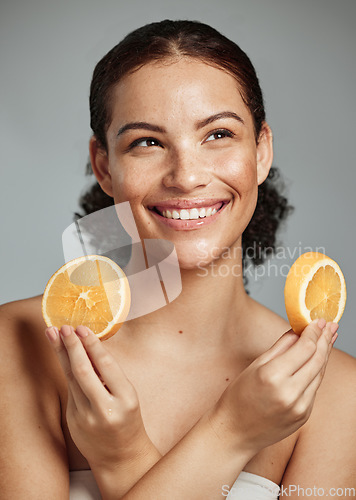 Image of Model, orange and hands in studio for skincare, health and wellness for cosmetic glow, self care and backdrop. Black woman, fruit aesthetic and diet for cosmetics, detox or natural skin by background