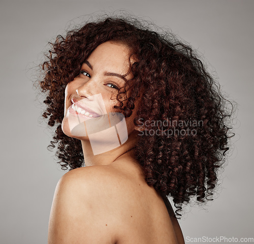 Image of Portrait, face and beauty with a model black woman in studio on a gray background for skincare treatment. Facial, wellness and natural with an attractive young female posing to promote a skin product