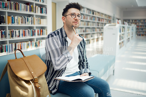 Image of University, student and thinking of idea in library for educational task with focus and notebook. Learning, knowledge and education of smart college man busy with assignment note ideas.