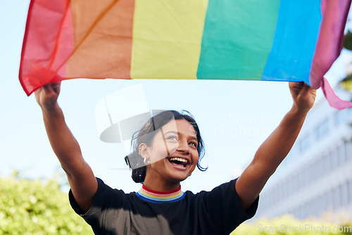 Image of Rainbow, flag and lgbt with an indian woman in the city in celebration of human rights, equality or freedom. Community, support and gay with a gender neutral or non binary female celebrating lgbtq