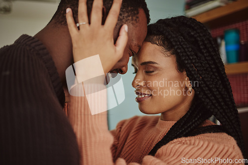 Image of Black couple, love and care while together for happiness in a happy marriage with commitment and care. Young man and woman touching face of head while in a house to bond, intimate and show commitment