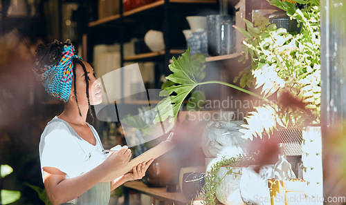 Image of Checklist, small business or black woman writing plants or flowers or plants for commerce or stock inventory. Management, store manager or entrepreneur planning or working on floral growth inspection