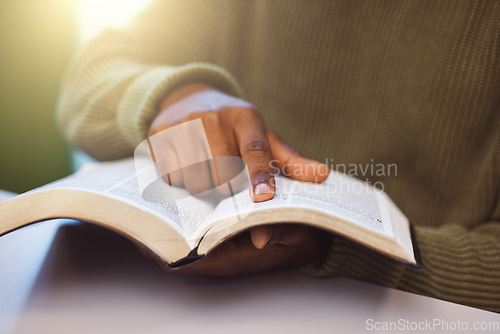 Image of Student, finger and reading book in university library, college campus or school classroom for education, learning or studying. Zoom, man and hand on research textbook for scholarship degree thesis