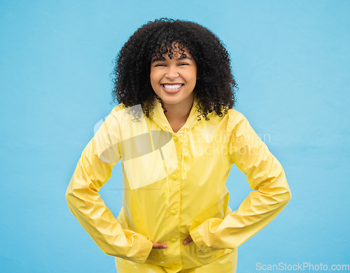 Image of Black woman, smile and happiness in portrait with rain coat,.fashion for winter and beauty isolated on blue background. Happy in studio, style and jacket with mockup, trendy and excited female