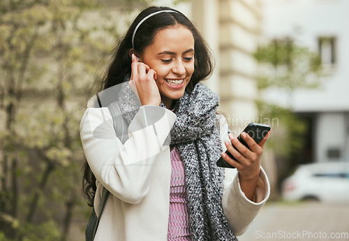 Image of Music, social media and woman with a phone in the city for gps location, app and communication in Italy. Podcast, radio and girl reading a chat on a mobile while streaming audio on an application