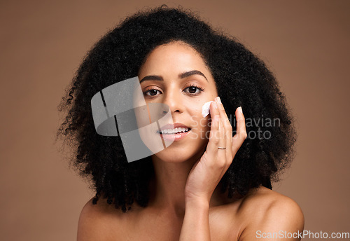 Image of Face, cream and black woman in studio for skincare, beauty and cosmetics promotion with product application in portrait. African model with skin care, dermatology and sunscreen wellness in a headshot