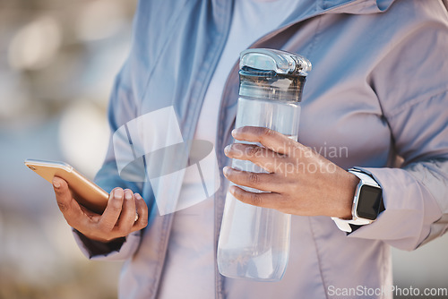 Image of Fitness, water and phone with hands of woman in mountain for jogging, workout or cardio training. Social media, progress tracker and running app with runner on path checking mobile for endurance goal