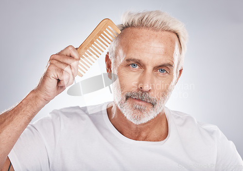 Image of Mature man, portrait and hair comb on studio background from barbershop, salon skincare and healthy cosmetics. Face, male model and brushing hair care for fashion, shampoo product and morning routine