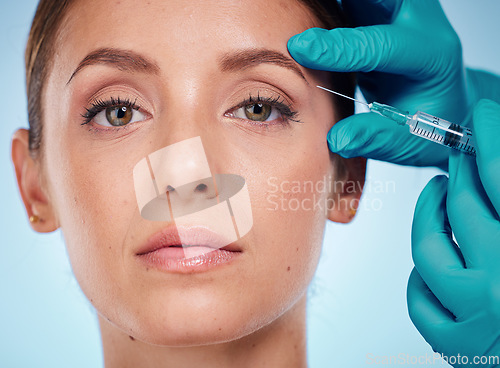 Image of Plastic surgery, skincare and woman with injection, healthcare and on blue studio background. Female, girl and botox with cosmetics, wellness and face care for health, soft and smooth skin for beauty