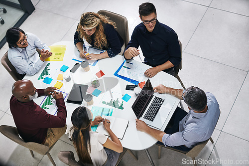 Image of Meeting, planning and top view of a team in the office discussing company report or proposal. Teamwork, diversity and marketing employees working on a creative project together in the workplace.