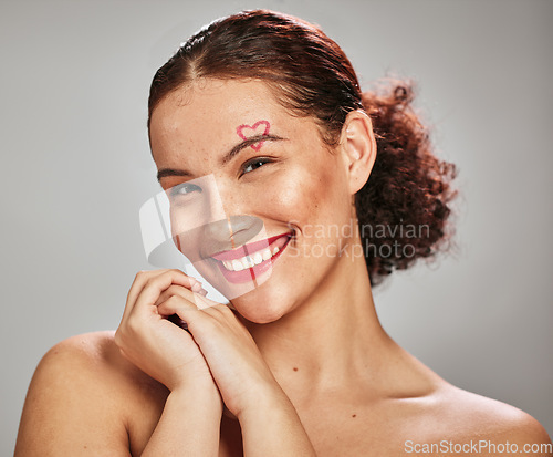 Image of Makeup heart, beauty portrait and happy woman model in studio for cosmetics and dermatology. Headshot of aesthetic person with red color lipstick for love and valentines day facial skincare idea