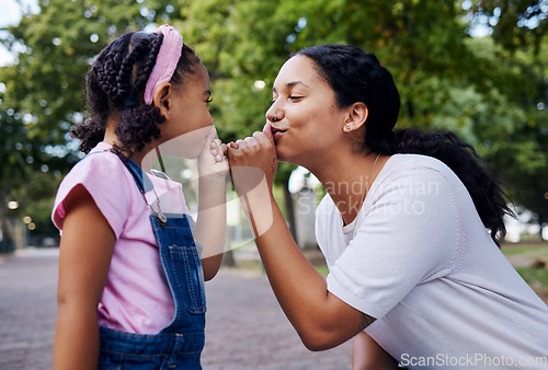 Image of Mom, child and fun playing park together with hands to mouth in cute kiss gesture on garden path. Love, happiness and mother and small girl have bonding time with outdoor games and happy development.