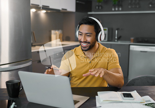 Image of Happy man, headphones and webinar or music on laptop in home office while talking online. Entrepreneur person at desk with virtual communication for freelance work with video conference for learning