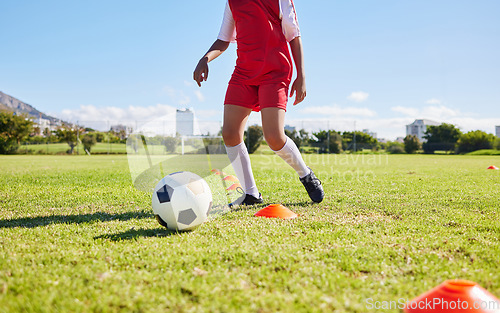 Image of Soccer child, field and training for fitness, sports and balance for control, speed and strong body development. Cropped football player kid, fast dribbling and exercise feet on grass in Cape Town