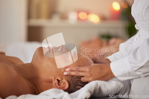 Image of Massage, reiki and couple at spa with therapist hand, chakra balance with wellness, spiritual and self care. Peace, zen and luxury service with masseuse, relax and mental health break holiday in Bali