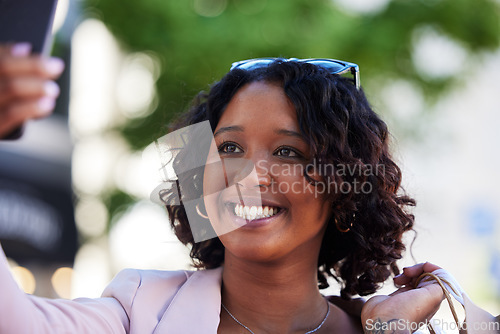 Image of Phone selfie, black woman and shopping in city for retail discount, fashion influencer or urban market sales. Happy shopper girl taking photograph on smartphone for social media, smile and technology