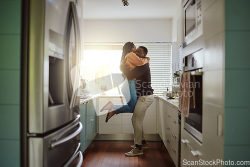 Image of Black couple, happy home and love while together with care and happiness in a marriage with commitment and care. Young man and woman hug while in the kitchen to celebrate their house or apartment