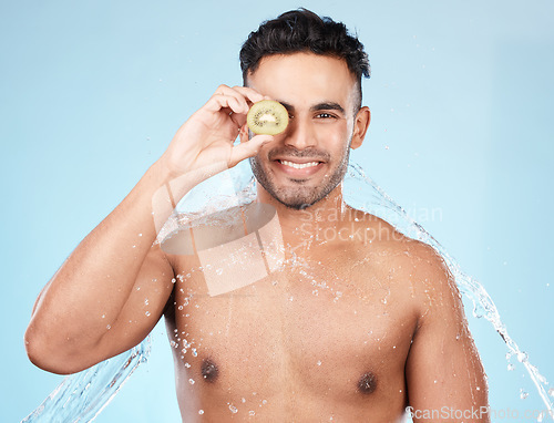 Image of Skincare, beauty and water splash, man with kiwi for vitamin c facial detox for healthcare, natural healthy skin and smile. Water, wellness and sustainability, organic luxurycleaning and grooming.