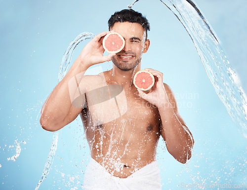 Image of Skincare, beauty and water splash, man with fruit for vitamin c facial detox for healthcare, natural healthy skin and smile. Water, wellness and sustainability, organic luxurycleaning and grooming.