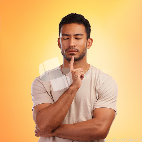 Image of Thinking, meditate and man in studio to focus, remember memory or decision on yellow background. Face of model person with hand on chin and eyes closed for meditation and to think of ideas and choice